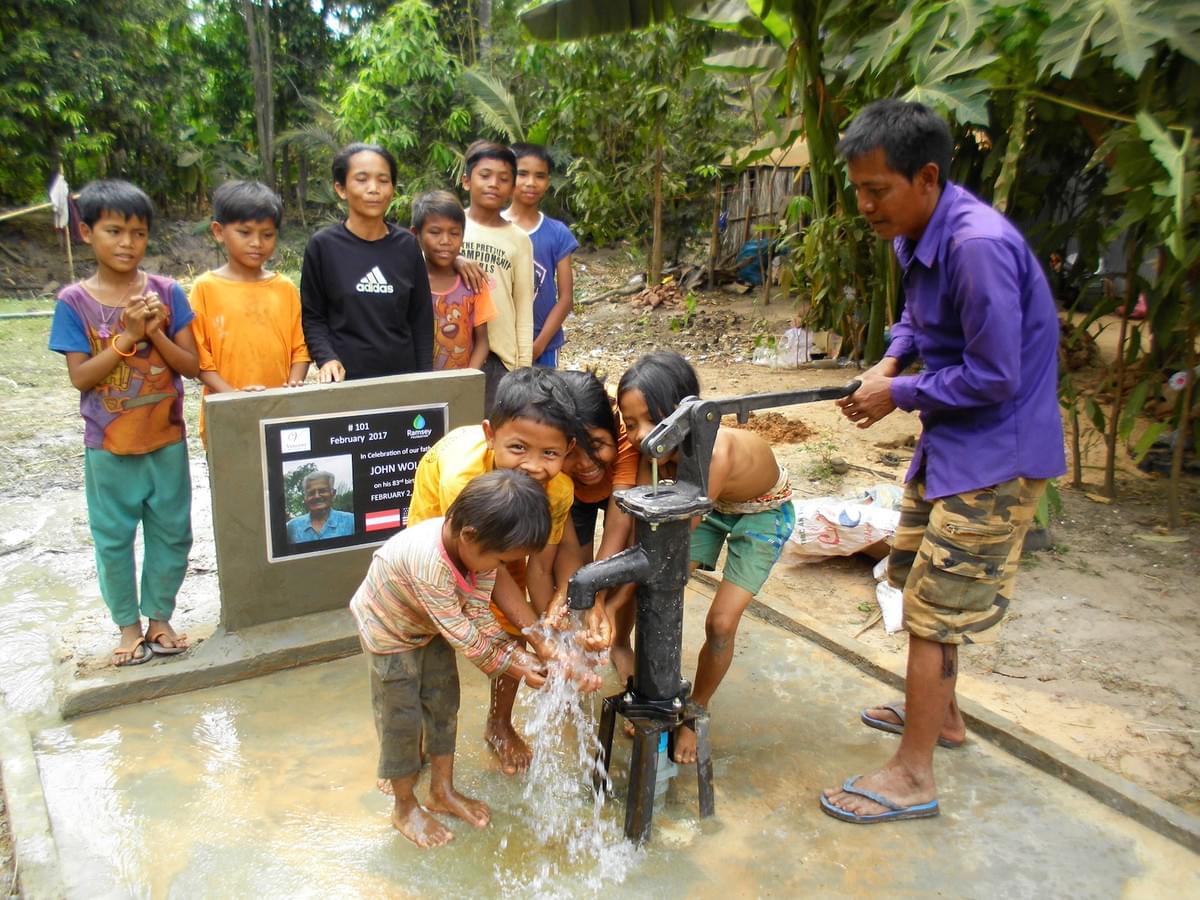 A large Cambodian Family enjoys the gift of access to fresh water through a well donated by MTRF