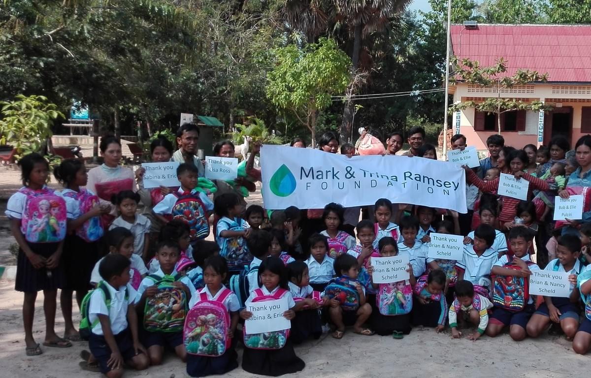 Cambodian Families expressing gratitude for school uniforms/backpacks/supplies and mosquito nets donated by supporters of Mark & Trina Ramsey Foundation