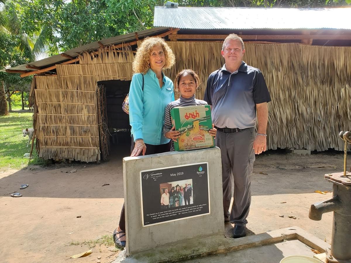 Mark & Trina pictured with the recipient of both a HOME and a well that were dedicated in loving memory of Liv