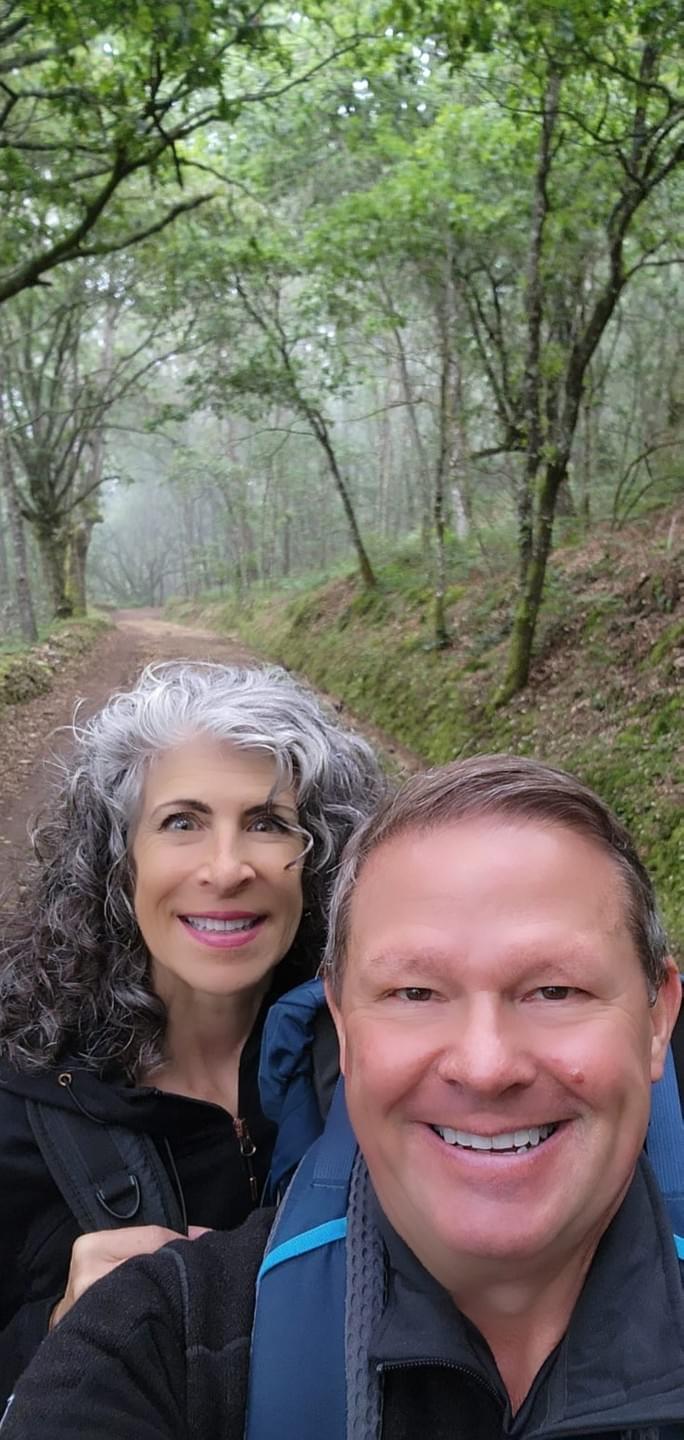 Mark and Trina Ramsey hiking a forest trail