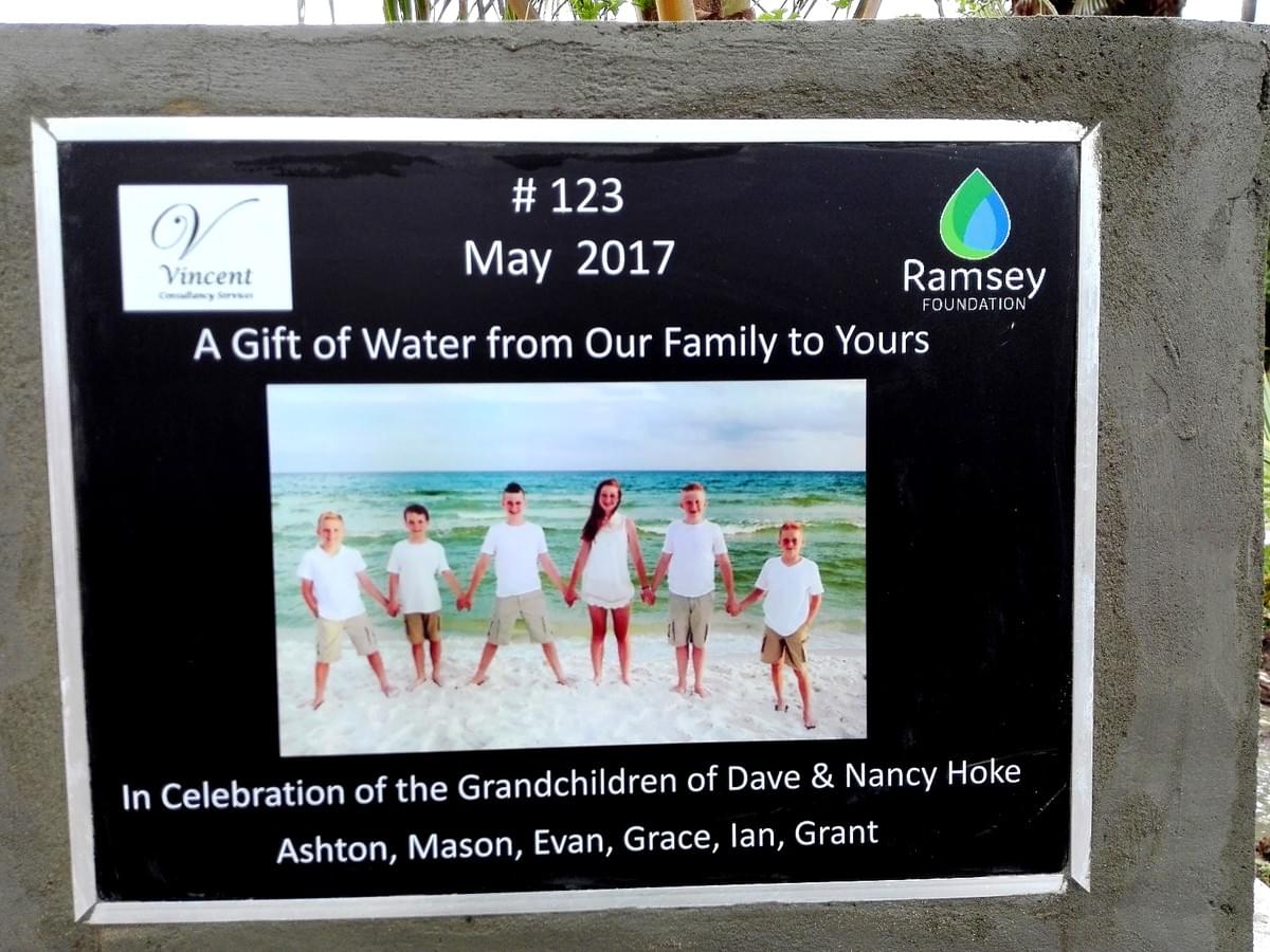 Banner on a Cambodian water well that was donated by Dave & Nancy Hoke in celebration of their Grandchildren