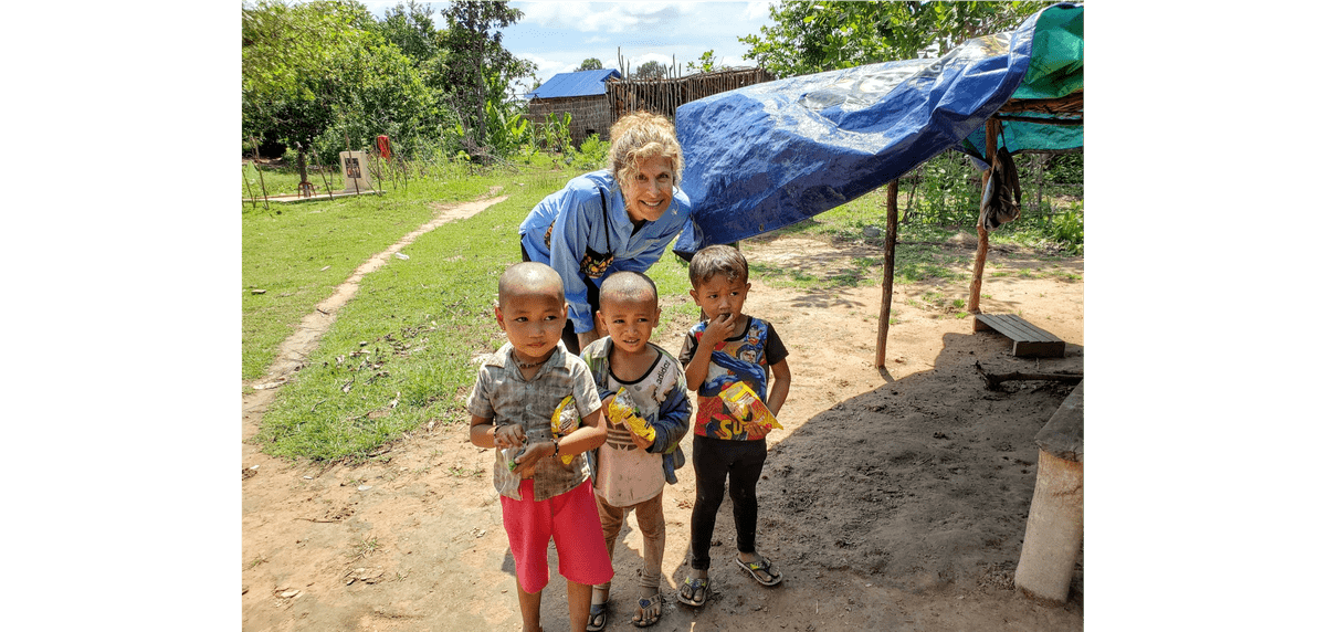 Trina with Cambodian children who are excited to receive their gift of noodles!