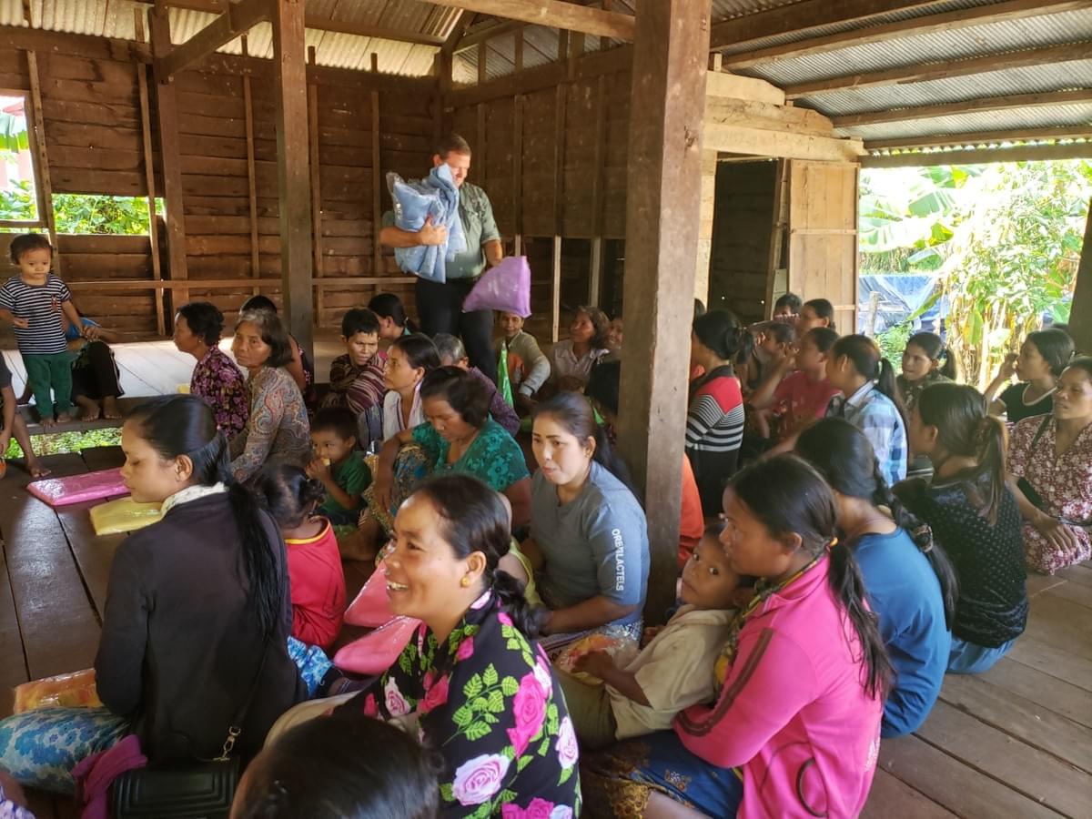Mark distributing mosquito nets to Cambodian villagers