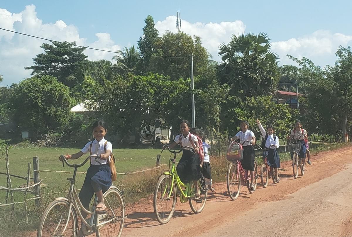 Cambodian School Children sharing donated bikes to travel to/from school Cambodian School Children sharing donated bikes to travel to/from school
