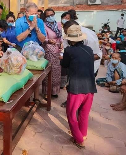 Bill Morse of RSSO and other volunteers distributing care packages containing rice, fish sauce, soy sauce, salt & sugar to pre-qualified Cambodian families in need
