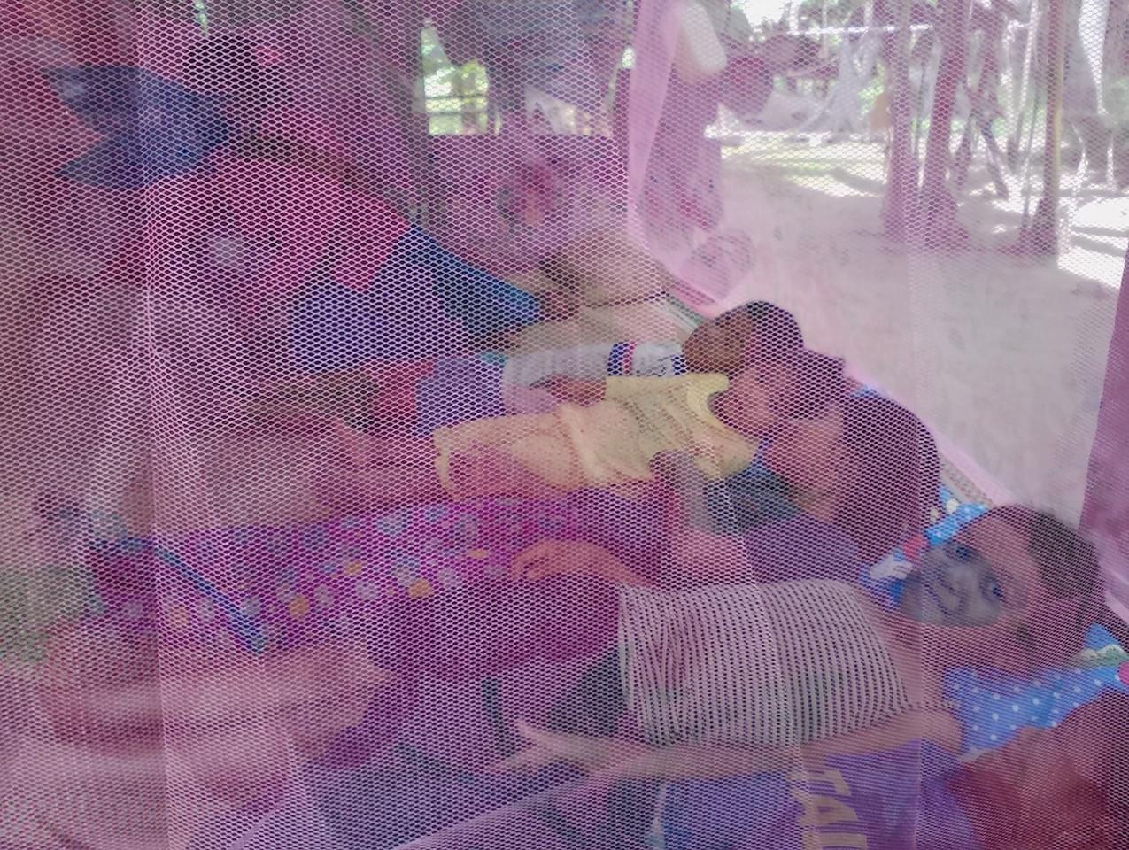 Children with mosquito nets in Cambodia