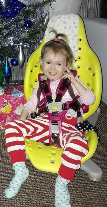 Image of Viktorie, in CZ, who, thanks to life-saving treatments is on a long road to a leading a healthier life.  She's now able to sit up unaided for a few minutes...huge progress!!